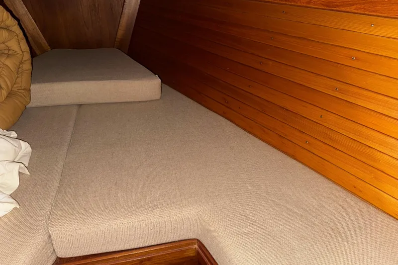 Slide: The Image of Interior cabin of 1988 Sabre 42 sailboat with wooden paneling and beige cushions. - 14