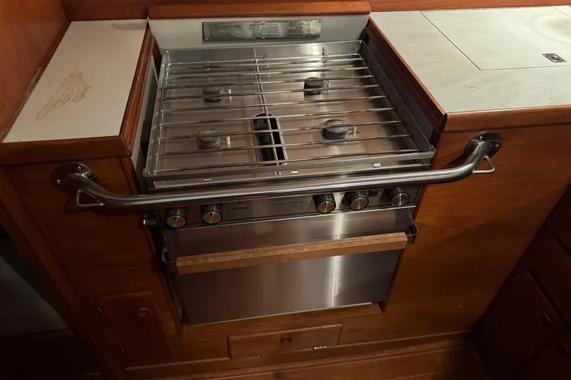 Slide: The Image of Stainless steel stove in 1988 Sabre 42 yacht kitchen, featuring dual burners and wooden cabinetry. - 17