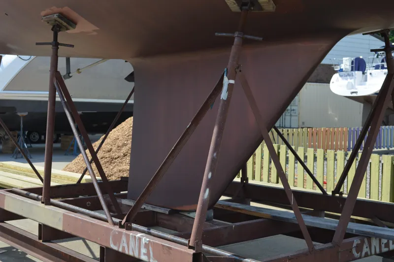 Slide: The Image of Keel of 1988 Sabre 42 sailboat on a metal stand in a boatyard. - 3