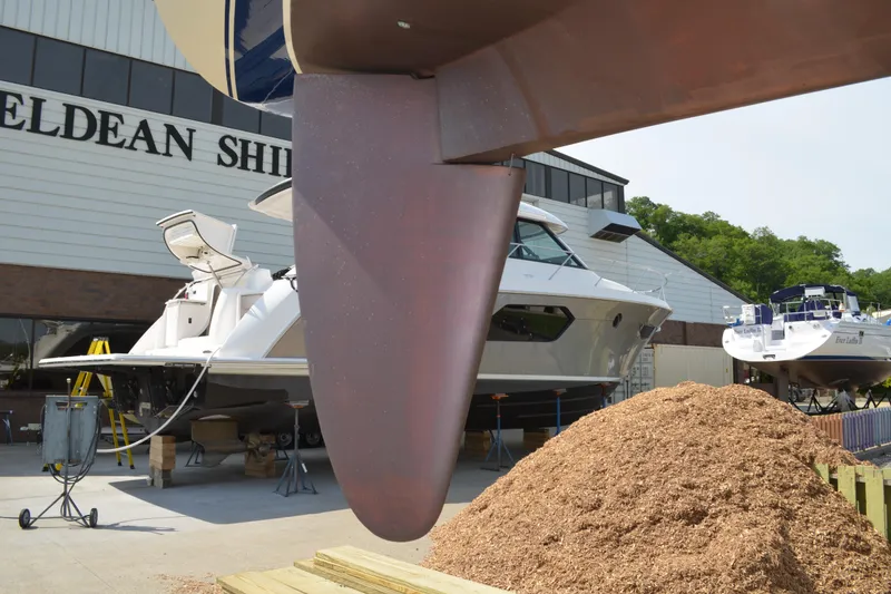Slide: The Image of 1988 Sabre 42 yacht at shipyard with wood shavings and other boats in background. - 4