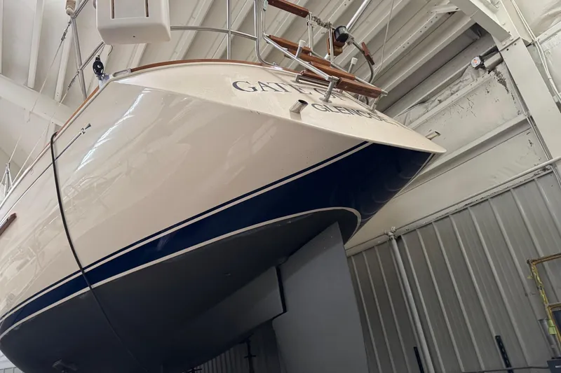 Slide: The Image of 1988 Sabre 42 sailboat in storage, showcasing its sleek hull design. - 5