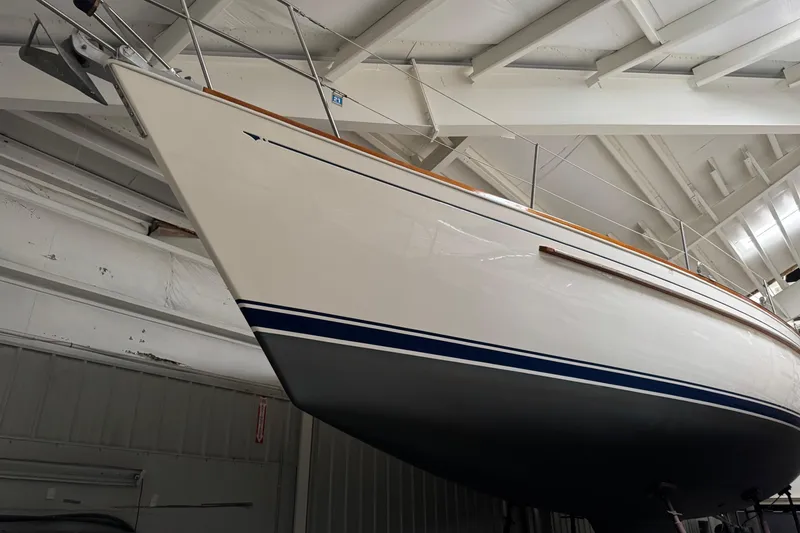 Slide: The Image of 1988 Sabre 42 sailboat in dry dock, showcasing sleek hull design and classic lines. - 6