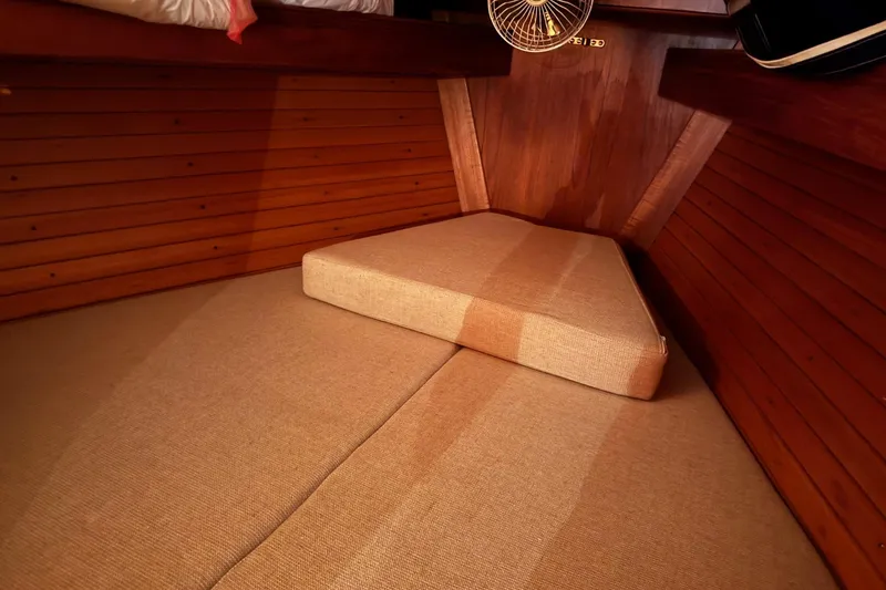 Slide: The Image of Cozy cabin interior of 1988 Sabre 42 sailboat with wooden paneling and beige cushions. - 9