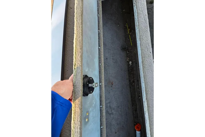 Slide: The Image of Hand adjusting component on 2002 Ranger 116 Cherokee boat interior. - 14