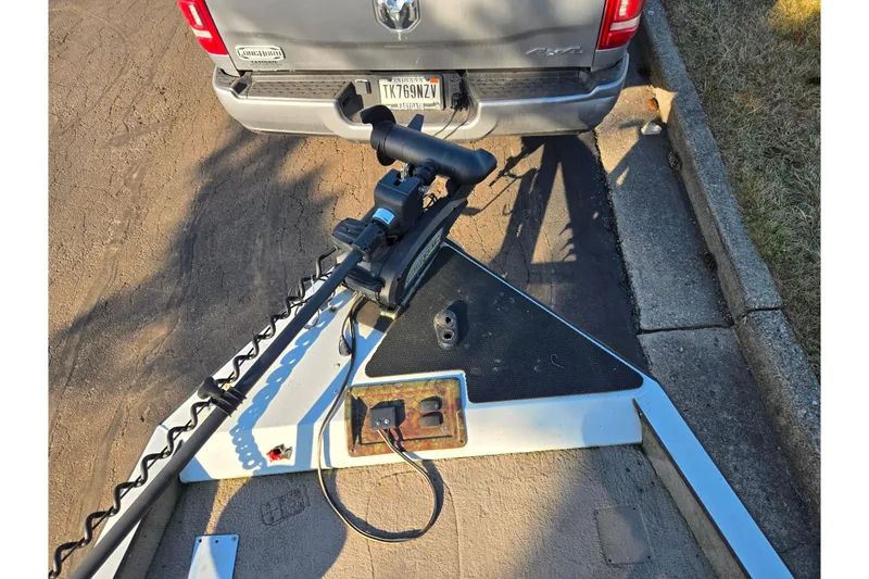 Slide: The Image of Ranger 116 Cherokee boat trailer hitched to a truck, parked on a street. - 16