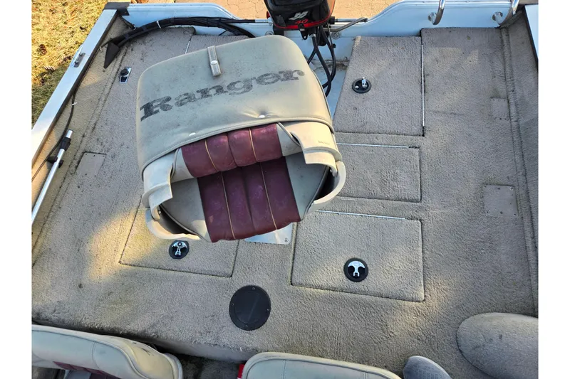 Slide: The Image of 2002 Ranger 116 Cherokee boat interior with seating and storage compartments. - 19