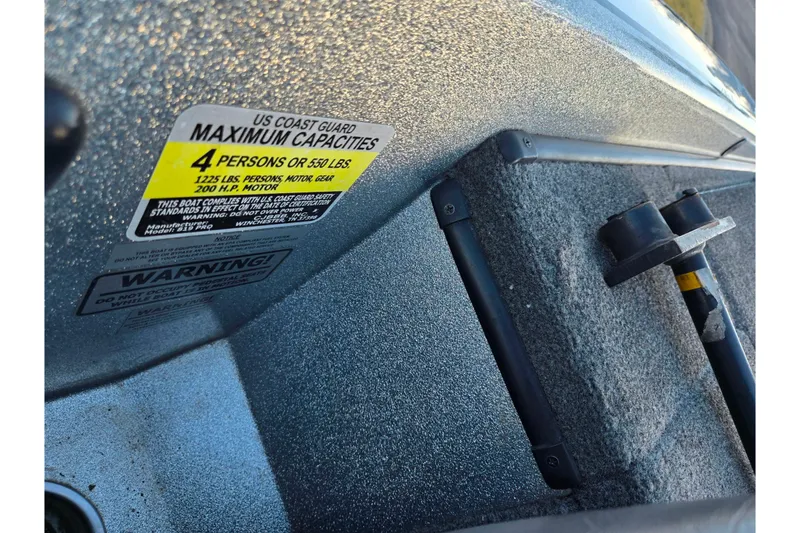 Slide: The Image of 2015 Phoenix 819 Pro boat capacity label, indicating maximum of 4 persons or 550 lbs. - 12