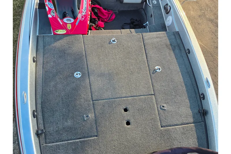 Slide: The Image of 2015 Phoenix 819 Pro boat deck with gray carpet and storage compartments. - 17