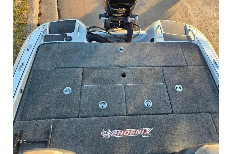 Slide: The Image of 2015 Phoenix 819 Pro boat deck with storage compartments and motor, featuring Phoenix logo. - 20