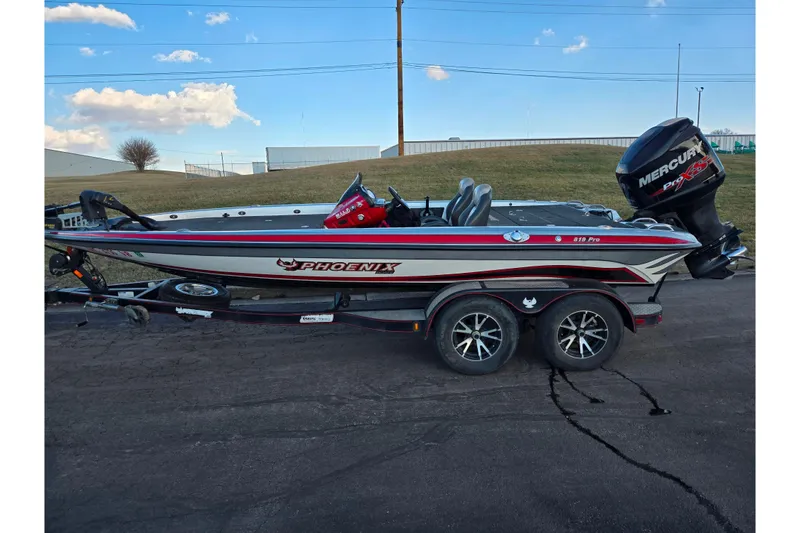 Slide: The Image of 2015 Phoenix 819 Pro boat with Mercury engine on trailer, parked outdoors. - 4