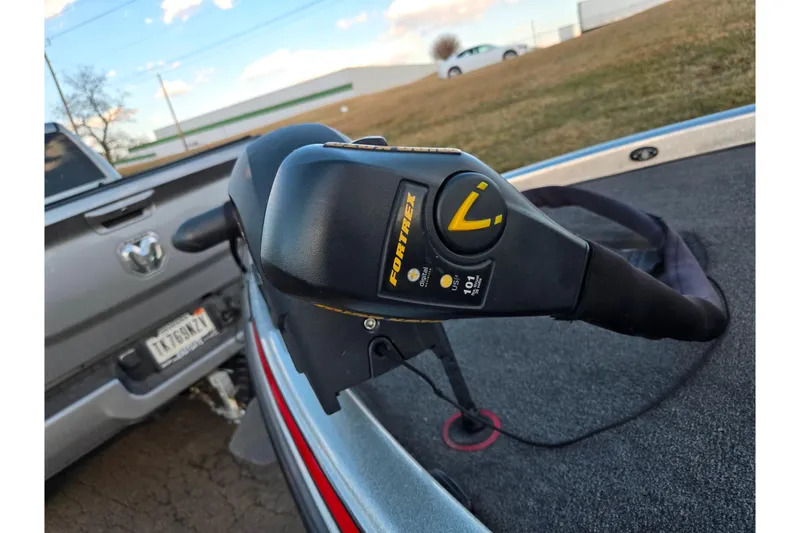 Slide: The Image of 2015 Phoenix 819 Pro boat with Fortrex trolling motor, parked near a truck. - 5