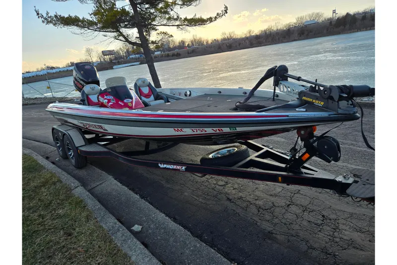 Slide: The Image of 2015 Phoenix 819 Pro boat on trailer by a lake at sunset. - 9