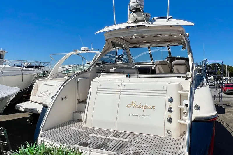 Slide: The Image of 2007 Windy Typhoon 43 yacht docked, surrounded by lush greenery. - 2