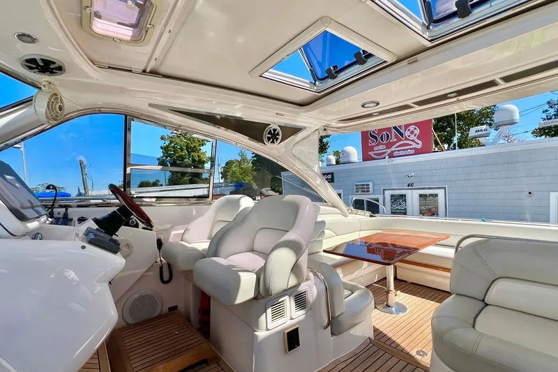 Slide: The Image of 2007 Windy Typhoon 43 yacht docked, featuring spacious deck and luxury seating. - 5