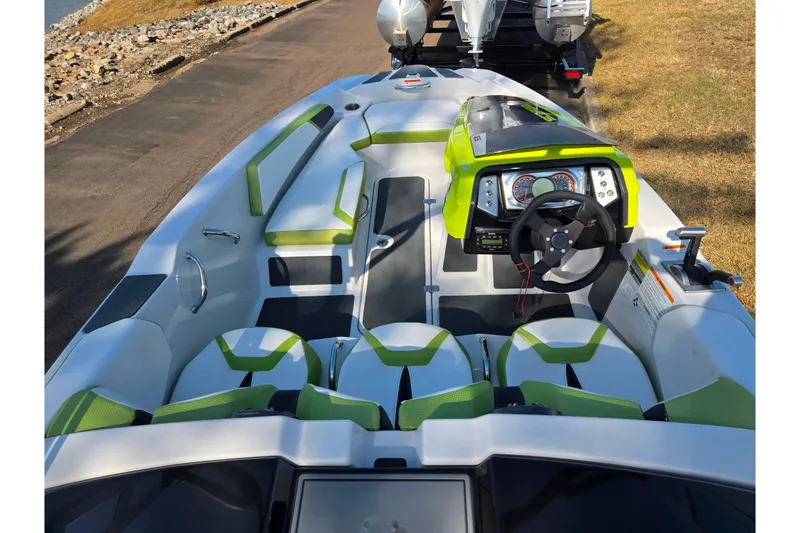 Slide: The Image of 2015 Scarab 165 H.O. Impulse boat interior with green accents and modern dashboard. - 10