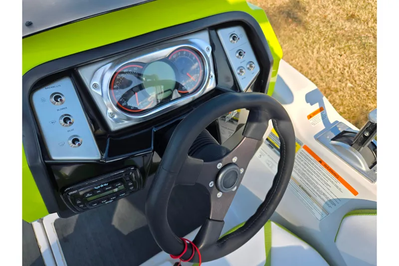 Slide: The Image of Dashboard of 2015 Scarab 165 H.O. Impulse boat with steering wheel and controls. - 11