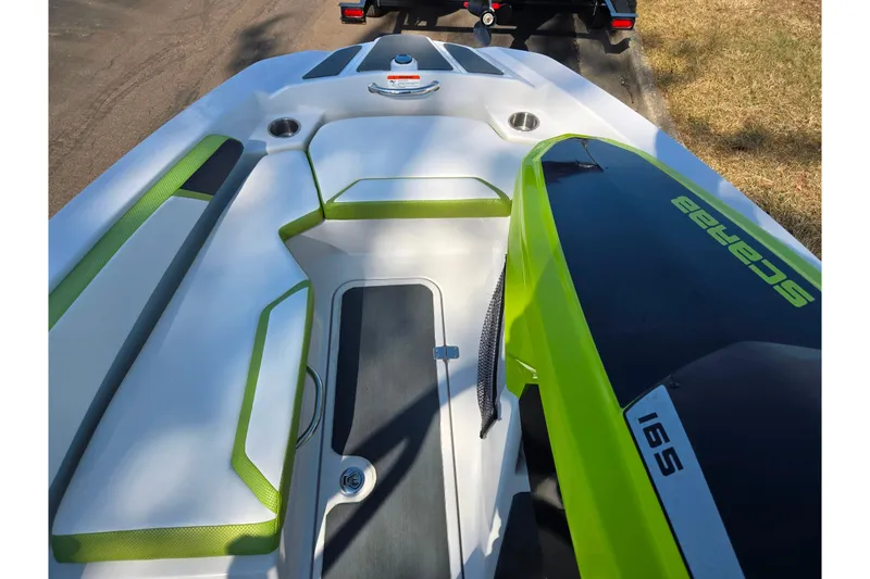 Slide: The Image of 2015 Scarab 165 H.O. Impulse boat interior with green accents and sleek design. - 13