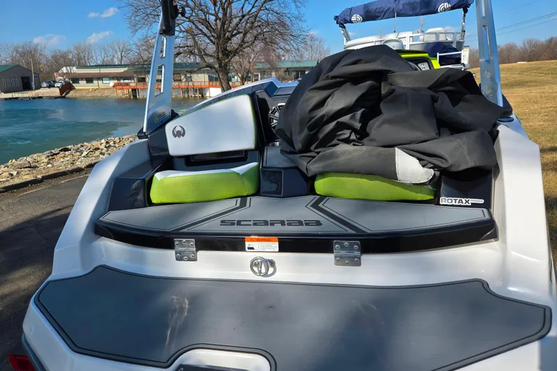 Slide: The Image of 2015 Scarab 165 H.O. Impulse boat with Rotax engine by a serene lake. - 2