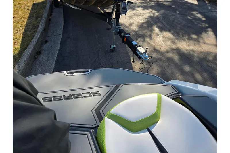 Slide: The Image of 2015 Scarab 165 H.O. Impulse boat on trailer, featuring sleek design and branding. - 21