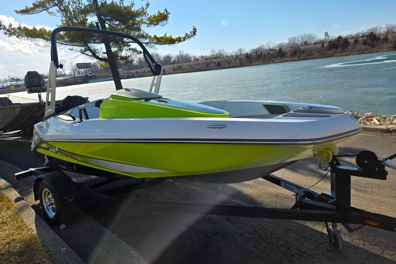 Slide: The Image of 2015 Scarab 165 H.O. Impulse boat on trailer by a scenic lake. - 8