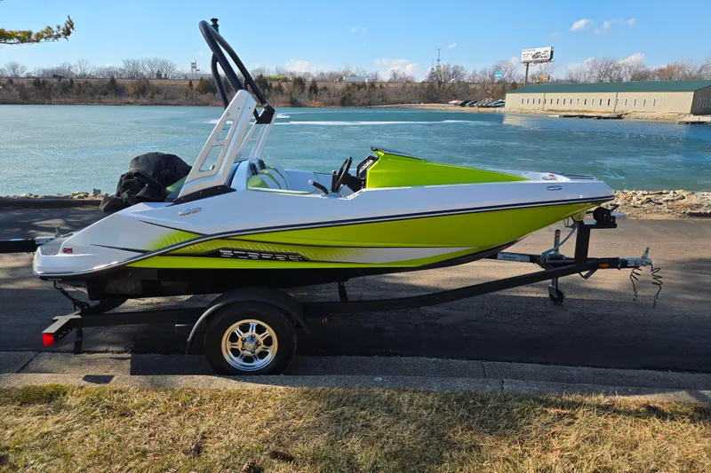 Slide: The Image of 2015 Scarab 165 H.O. Impulse boat on trailer by a river. - 9
