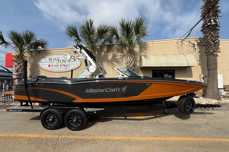Slide: The Image of 2017 MasterCraft X46 boat on trailer, parked outside Boat Town dealership. - 0