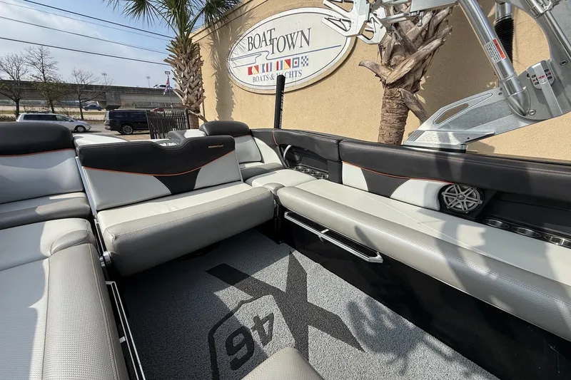 Slide: The Image of 2017 MasterCraft X46 boat interior with sleek seating, parked at Boat Town dealership. - 12