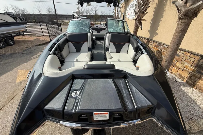 Slide: The Image of 2017 MasterCraft X46 boat with sleek black exterior and spacious seating. - 2