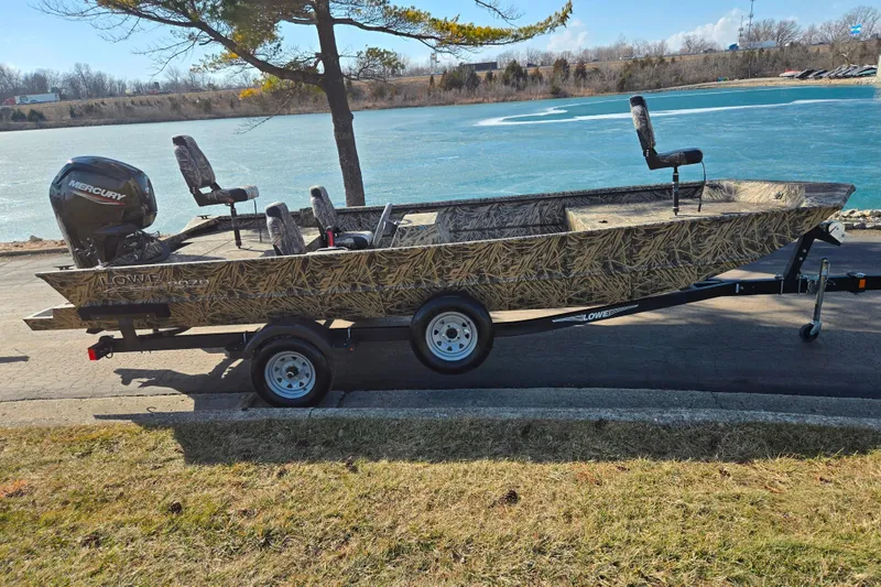 Slide: The Image of 2020 Lowe Roughneck 2070SC boat with Mercury engine on trailer by a lake. - 10