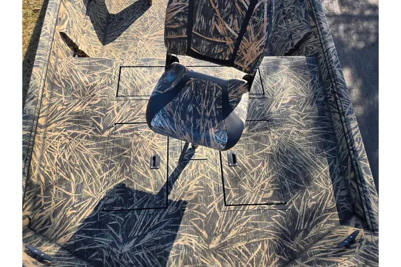 Slide: The Image of 2020 Lowe Roughneck 2070SC boat interior with camouflage seating and storage compartments. - 18