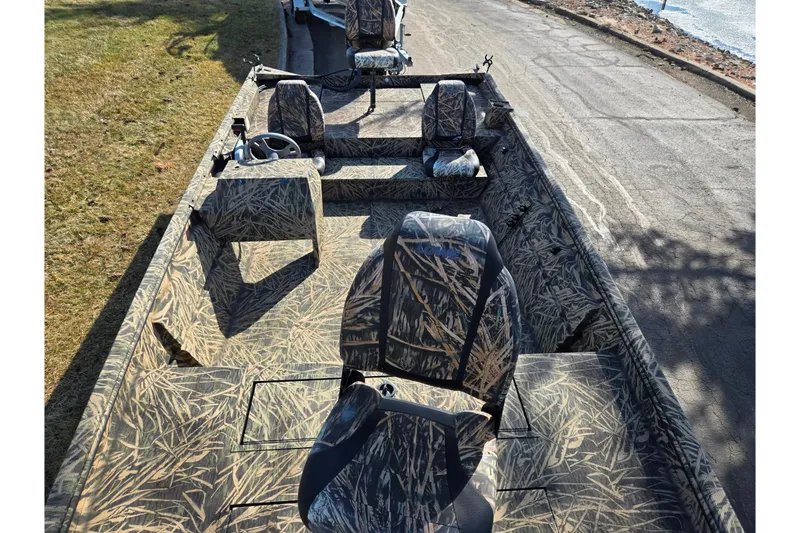 Slide: The Image of 2020 Lowe Roughneck 2070SC boat with camouflage interior design on a sunny day. - 19