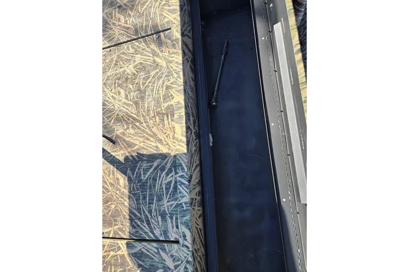 Slide: The Image of 2020 Lowe Roughneck 2070SC boat interior with camouflage pattern and storage compartment. - 22