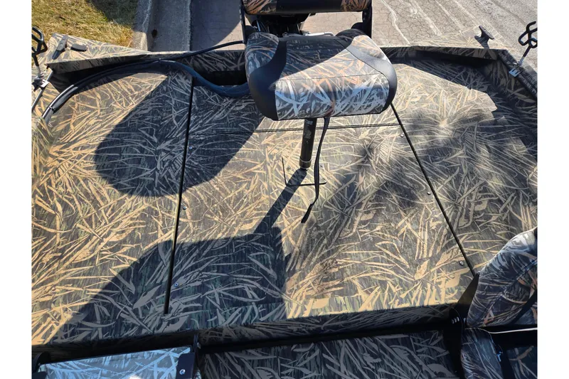 Slide: The Image of 2020 Lowe Roughneck 2070SC boat interior with camouflage seating and flooring. - 23