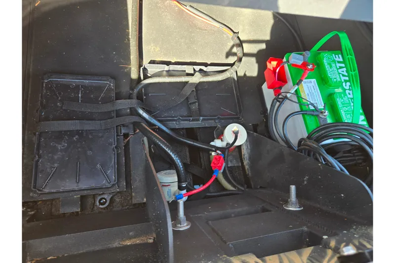 Slide: The Image of 2020 Lowe Roughneck 2070SC boat battery compartment with wiring and Interstate battery. - 24