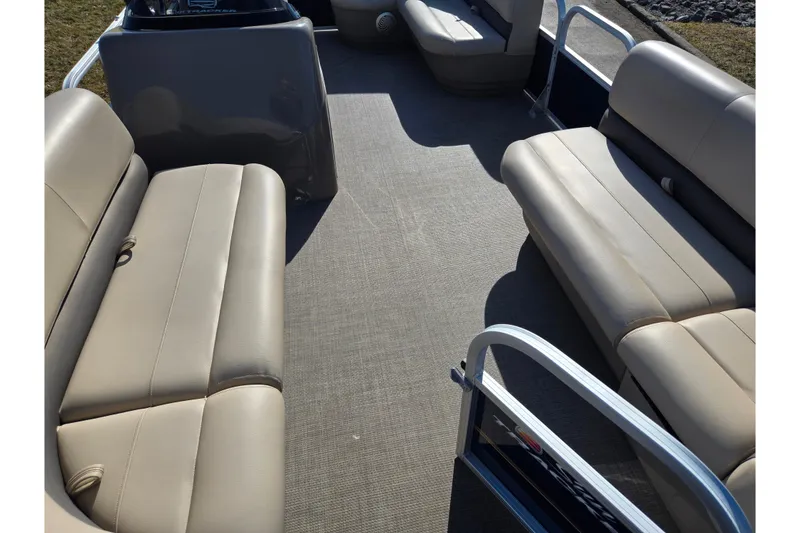 Slide: The Image of 2021 Sun Tracker Party Barge 18 DLX interior with beige seating and spacious layout. - 10