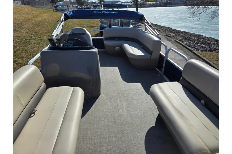Slide: The Image of 2021 Sun Tracker Party Barge 18 DLX pontoon boat interior with seating and steering console. - 11