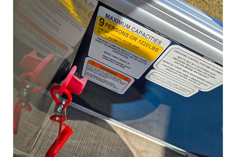 Slide: The Image of 2021 Sun Tracker Party Barge 18 DLX capacity label, showing 9-person or 1220 lbs limit. - 19