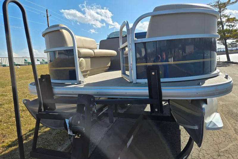 Slide: The Image of 2021 Sun Tracker Party Barge 18 DLX pontoon boat on trailer, sunny day. - 6