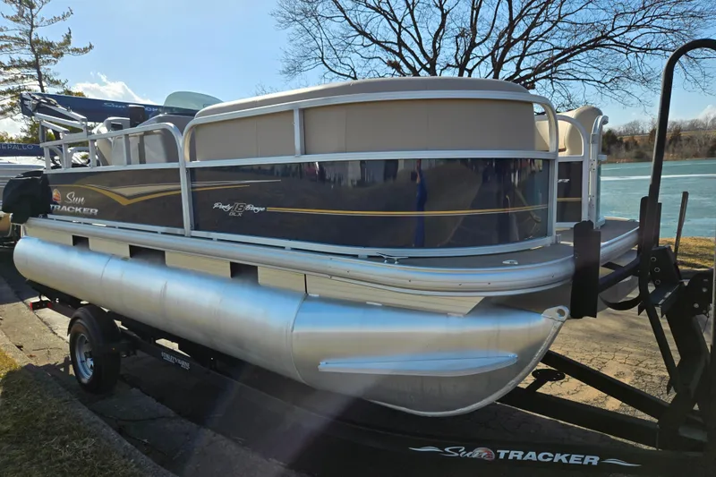 Slide: The Image of 2021 Sun Tracker Party Barge 18 DLX pontoon boat on trailer by a lake. - 8