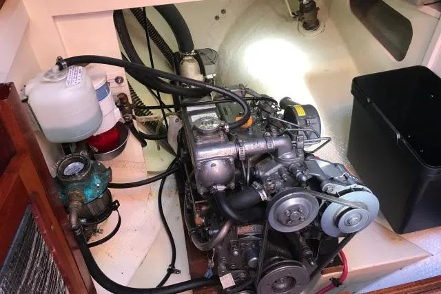 Slide: The Image of Engine compartment of a 1997 Bristol Channel Cutter 28 sailboat, showcasing mechanical components. - 10