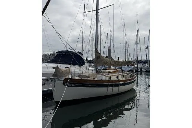 Slide: The Image of 1997 Bristol Channel Cutter 28 sailboat docked in a marina, overcast sky. - 13