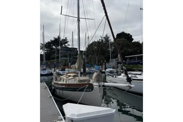Slide: The Image of Bristol Channel Cutter 28 sailboat, 1997 model, docked in a marina with overcast skies. - 15