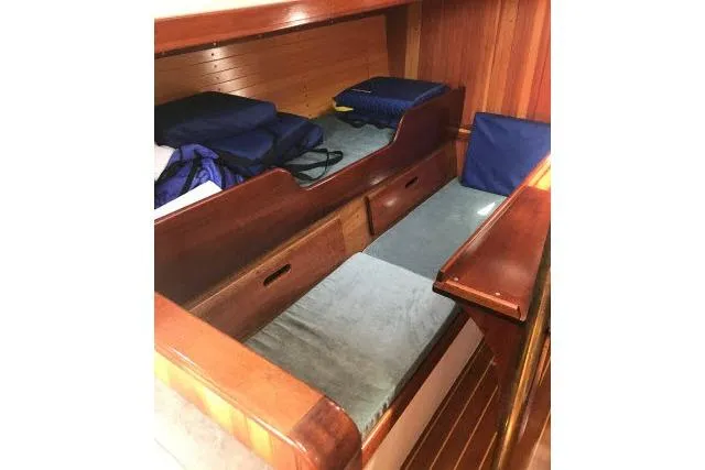 Slide: The Image of Interior cabin of 1997 Bristol Channel Cutter 28 with wooden finish and storage. - 3