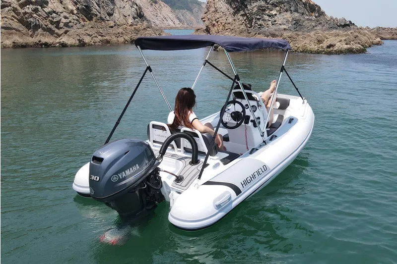 Slide: The Image of Manufacturer Provided Image: 2021 Highfield Sport 330 boat with Yamaha engine on calm water. - 11