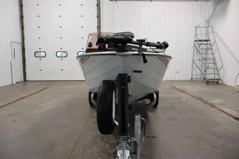Slide: The Image of 1990 Lowe 1620V boat on trailer in a spacious garage. - 2