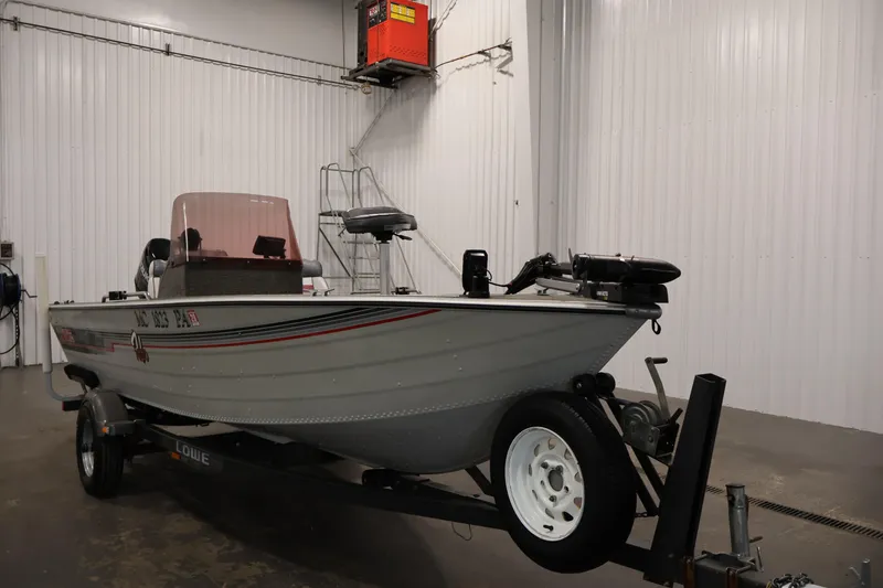 Slide: The Image of 1990 Lowe 1620V boat on trailer in indoor storage facility. - 3