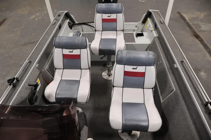 Slide: The Image of Interior of a 1990 Lowe 1620V boat with three cushioned seats. - 30