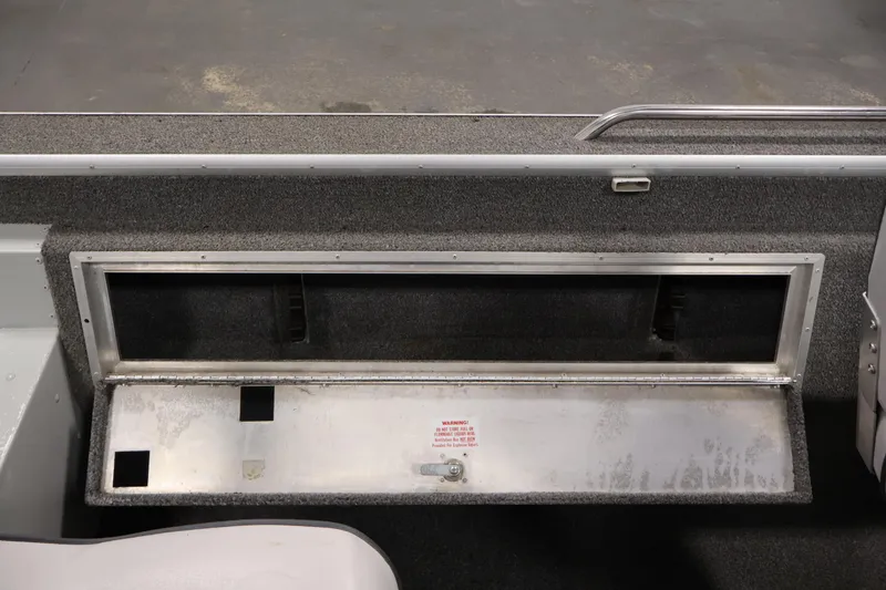 Slide: The Image of Interior view of a 1990 Lowe 1620V boat storage compartment with open hatch. - 32