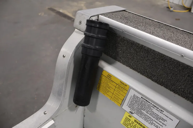 Slide: The Image of Interior of a 1990 Lowe 1620V boat showing a rod holder and safety checklist. - 37