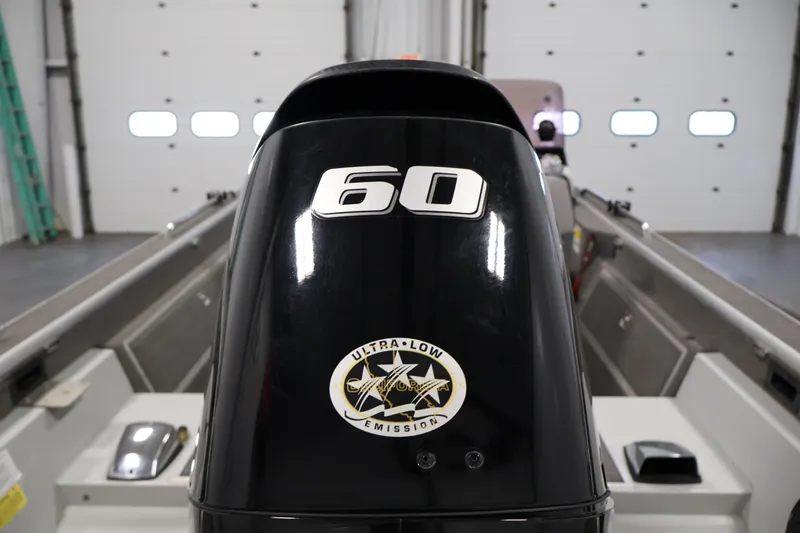 Slide: The Image of 1990 Lowe 1620V boat with 60 HP ultra-low emission engine in a garage. - 41